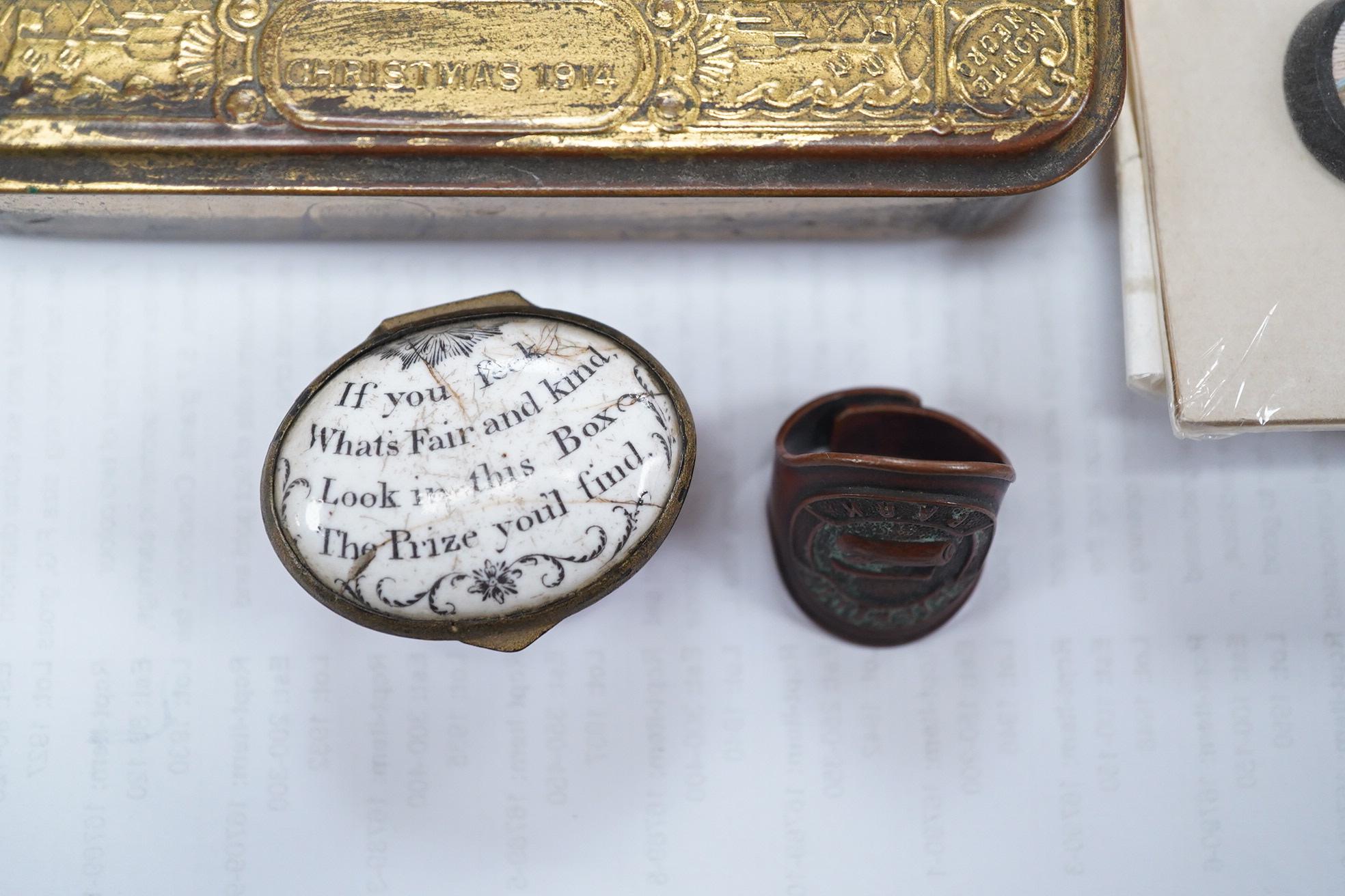 An 18th century enamel patch box with motto and four Italian Grand tour style micro-mosaic panels, housed in a 1914 Christmas tin. Condition - fair